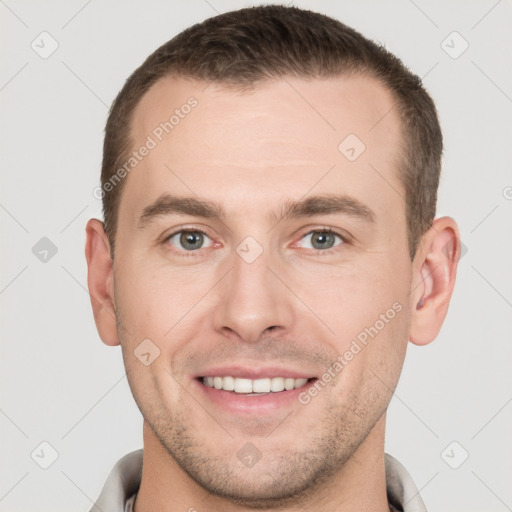 Joyful white young-adult male with short  brown hair and grey eyes