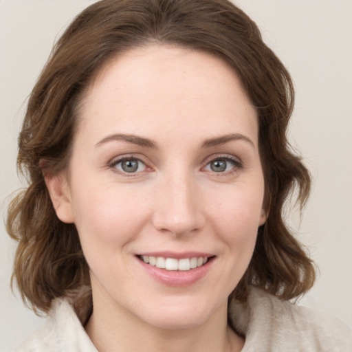 Joyful white young-adult female with medium  brown hair and blue eyes