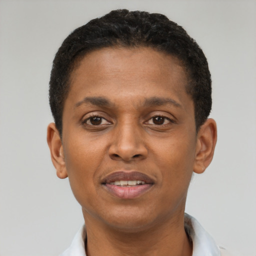 Joyful latino young-adult male with short  brown hair and brown eyes