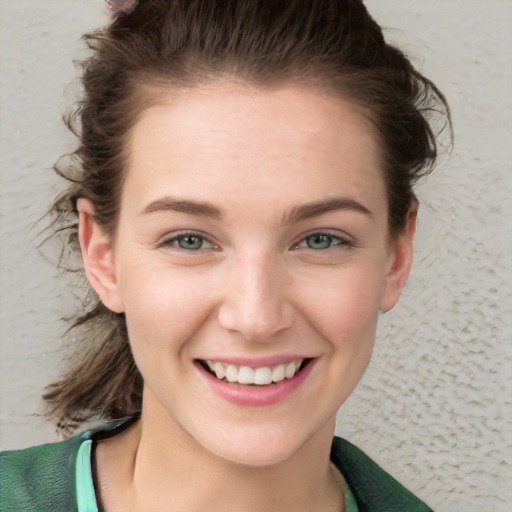 Joyful white young-adult female with short  brown hair and green eyes