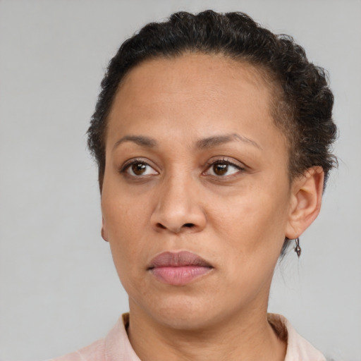 Joyful black adult female with short  brown hair and brown eyes