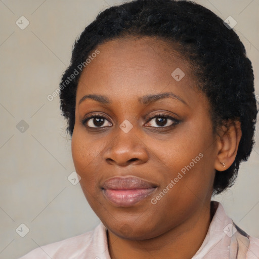 Joyful black young-adult female with short  black hair and brown eyes