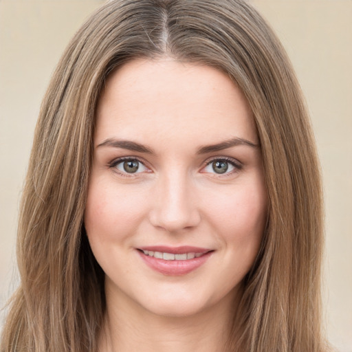 Joyful white young-adult female with long  brown hair and green eyes