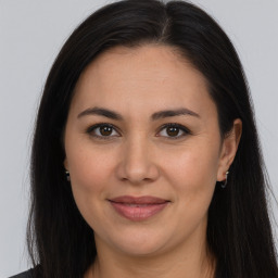 Joyful white adult female with long  brown hair and brown eyes