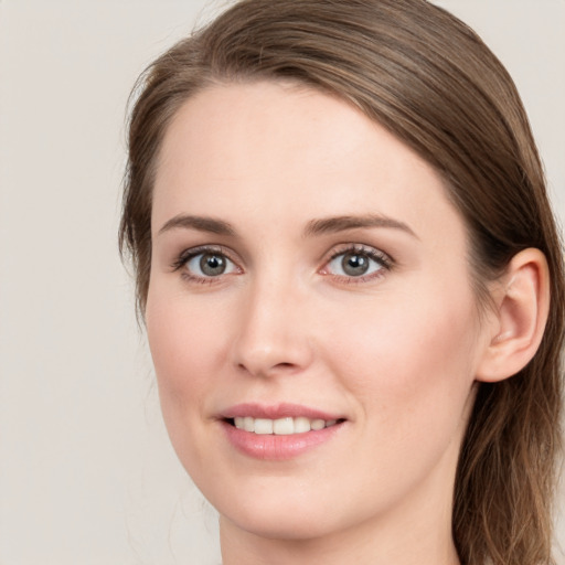 Joyful white young-adult female with long  brown hair and green eyes