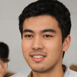 Joyful asian young-adult male with short  black hair and brown eyes