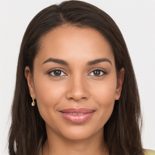 Joyful white young-adult female with long  brown hair and brown eyes