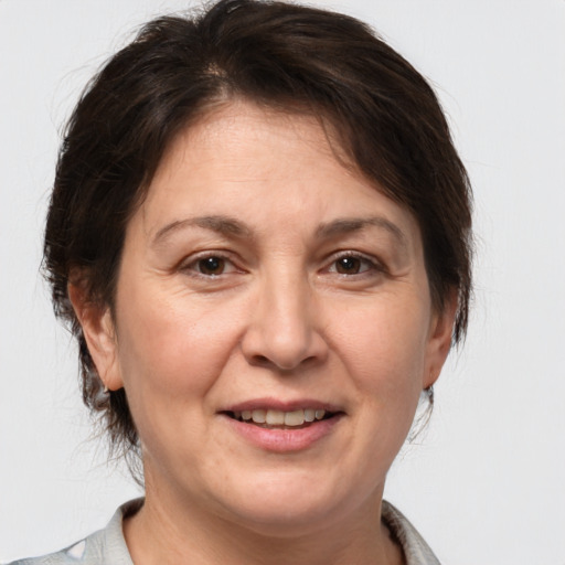 Joyful white adult female with medium  brown hair and brown eyes