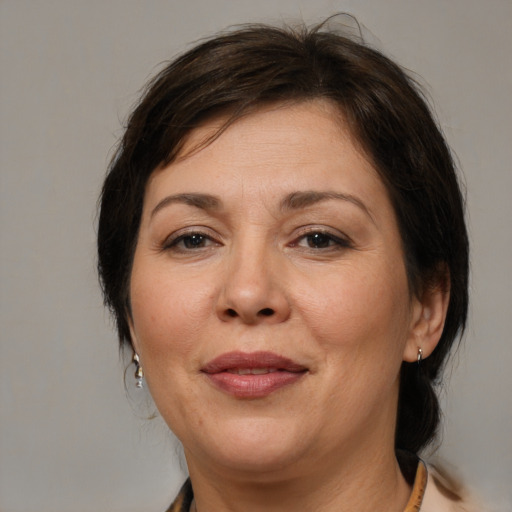 Joyful white adult female with medium  brown hair and brown eyes