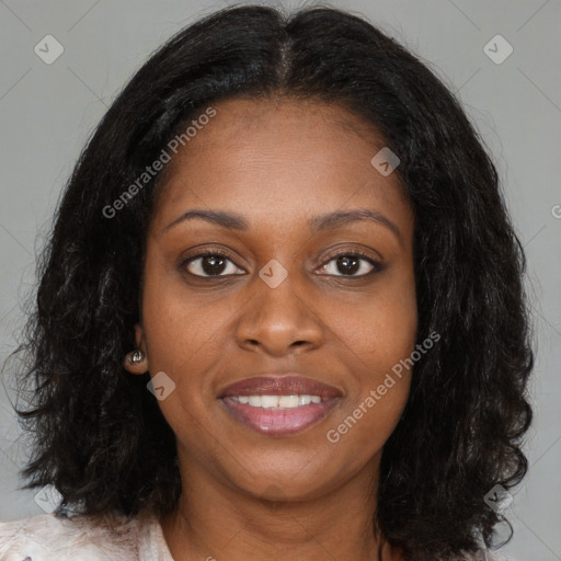 Joyful black young-adult female with long  brown hair and brown eyes