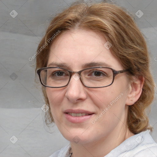 Joyful white adult female with medium  brown hair and blue eyes