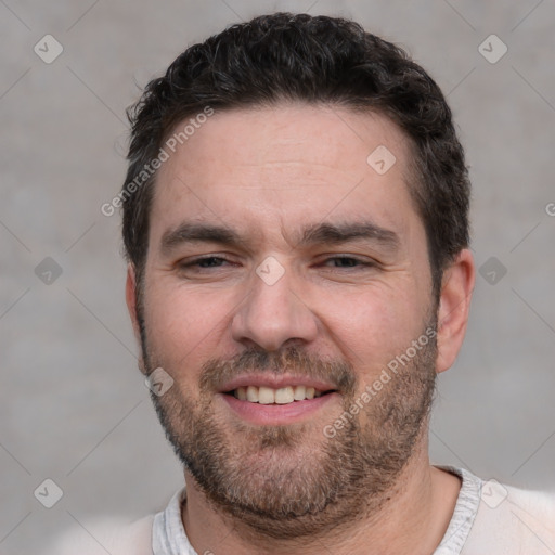 Joyful white adult male with short  black hair and brown eyes