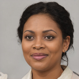 Joyful black adult female with medium  brown hair and brown eyes