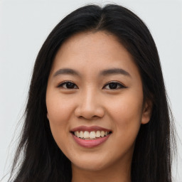 Joyful asian young-adult female with long  brown hair and brown eyes