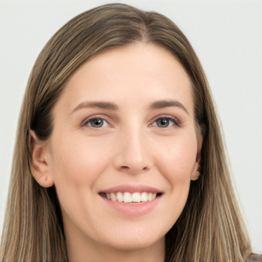 Joyful white young-adult female with long  brown hair and grey eyes