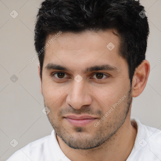 Joyful white young-adult male with short  black hair and brown eyes