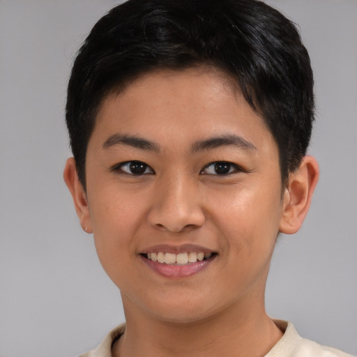 Joyful asian child female with short  brown hair and brown eyes