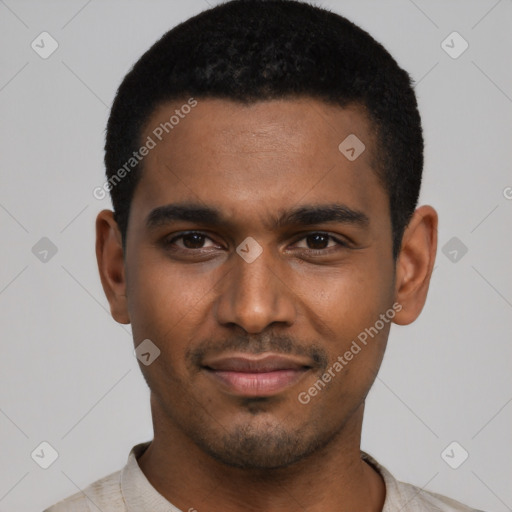 Joyful black young-adult male with short  black hair and brown eyes