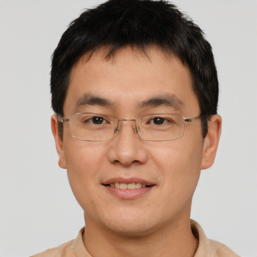 Joyful asian young-adult male with short  brown hair and brown eyes