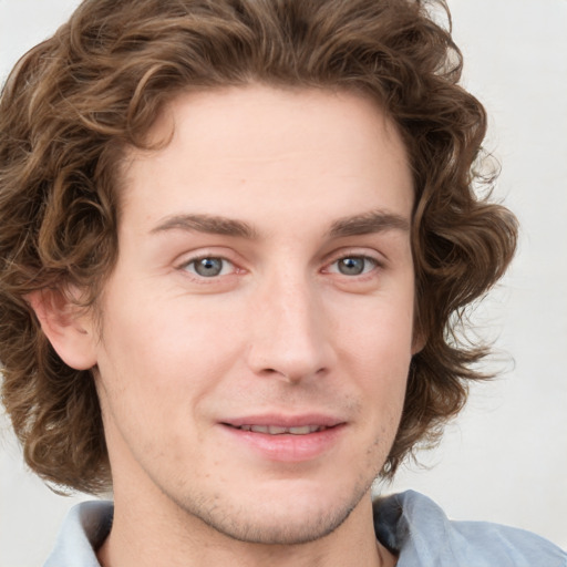 Joyful white young-adult male with medium  brown hair and grey eyes