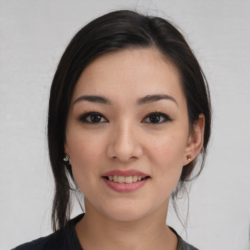Joyful white young-adult female with medium  black hair and brown eyes
