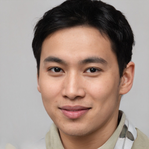 Joyful asian young-adult male with short  brown hair and brown eyes