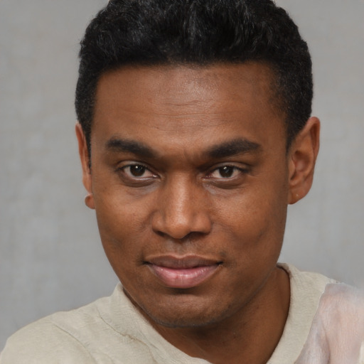 Joyful black young-adult male with short  black hair and brown eyes