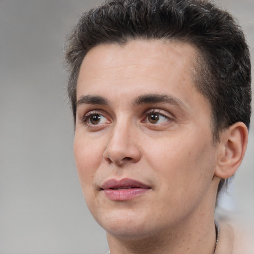 Joyful white adult male with short  brown hair and brown eyes