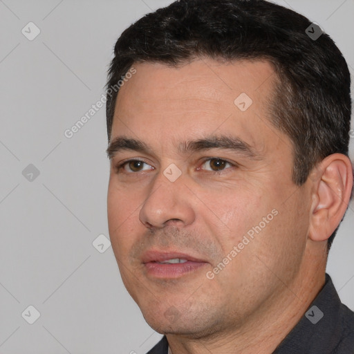 Joyful white adult male with short  black hair and brown eyes