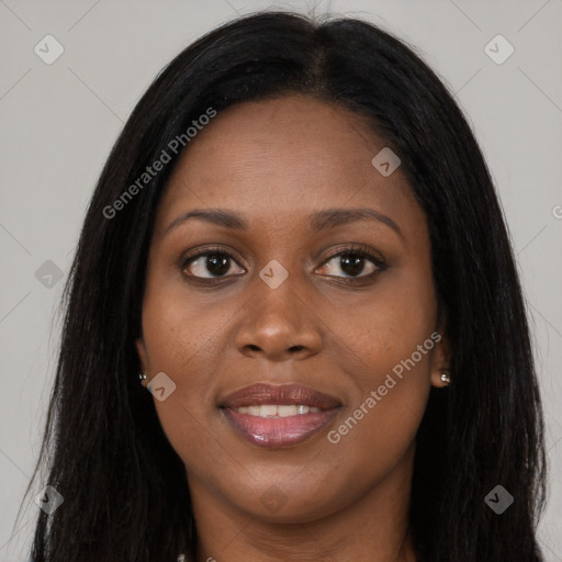 Joyful black young-adult female with long  brown hair and brown eyes