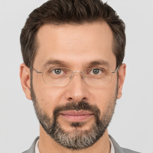 Joyful white adult male with short  brown hair and brown eyes