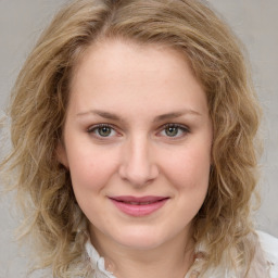 Joyful white young-adult female with medium  brown hair and green eyes