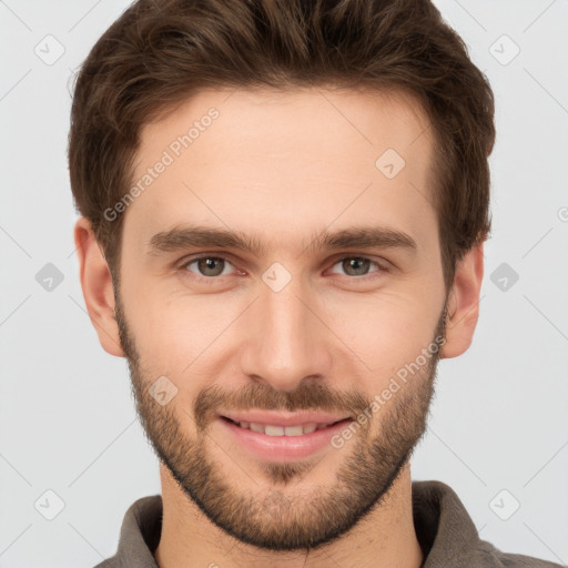 Joyful white young-adult male with short  brown hair and grey eyes