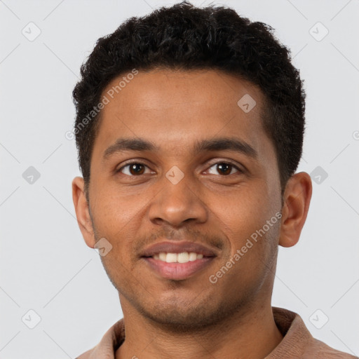 Joyful black young-adult male with short  brown hair and brown eyes