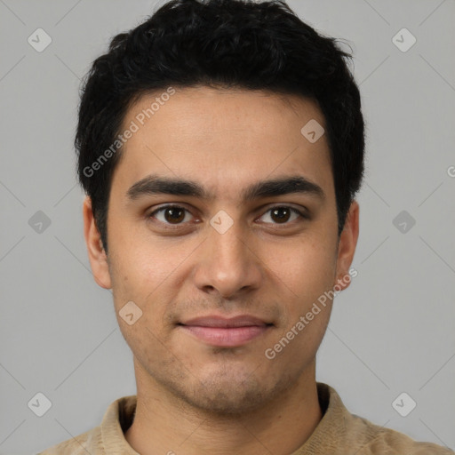 Joyful latino young-adult male with short  brown hair and brown eyes