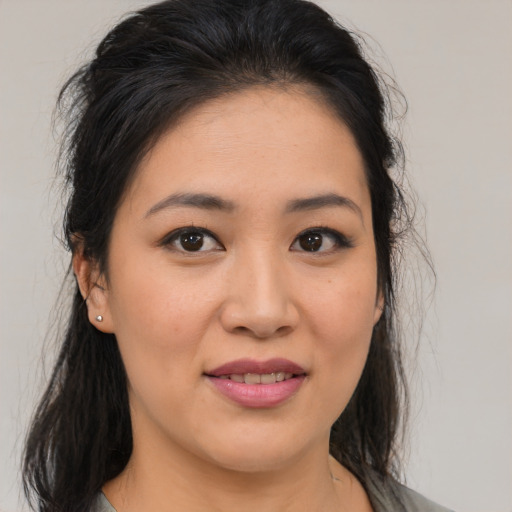 Joyful asian young-adult female with medium  brown hair and brown eyes