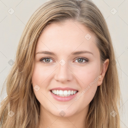 Joyful white young-adult female with long  brown hair and green eyes