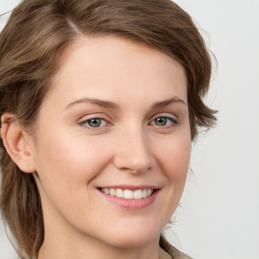 Joyful white young-adult female with medium  brown hair and green eyes