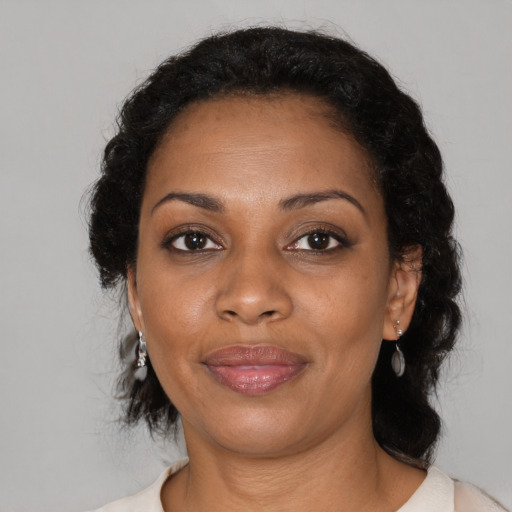 Joyful black adult female with medium  black hair and brown eyes