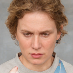 Joyful white adult female with short  brown hair and blue eyes