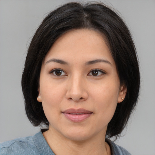 Joyful asian young-adult female with medium  brown hair and brown eyes