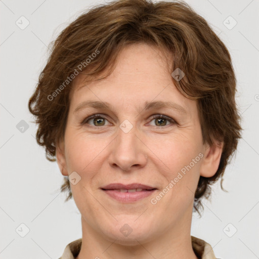 Joyful white adult female with medium  brown hair and green eyes