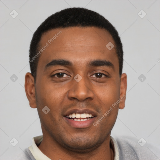 Joyful black young-adult male with short  black hair and brown eyes