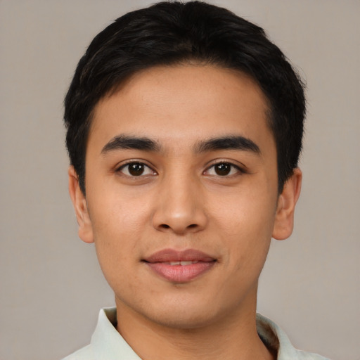 Joyful asian young-adult male with short  black hair and brown eyes