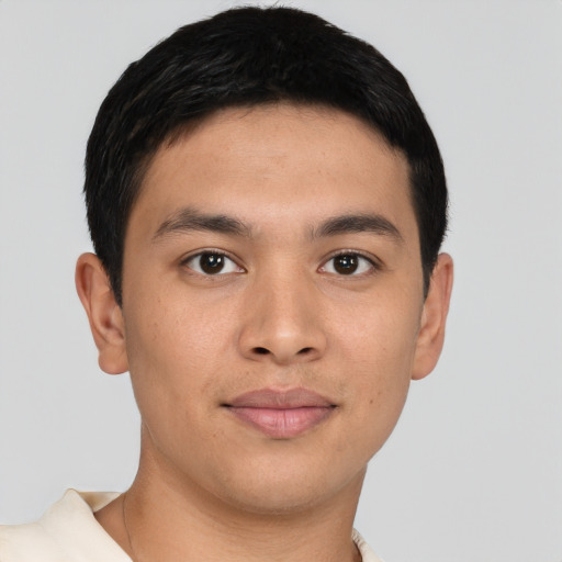 Joyful asian young-adult male with short  brown hair and brown eyes