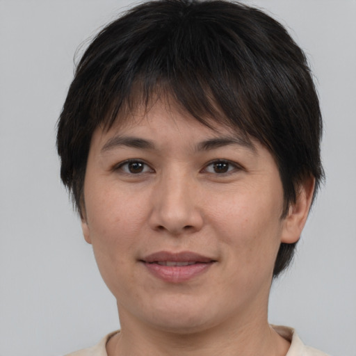 Joyful white adult female with short  brown hair and brown eyes