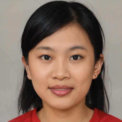 Joyful asian young-adult female with medium  black hair and brown eyes