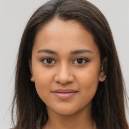 Joyful latino young-adult female with long  brown hair and brown eyes