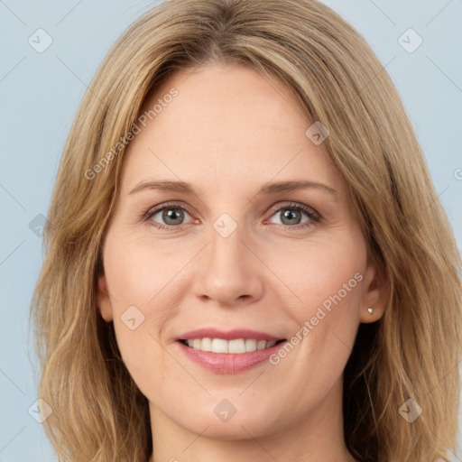 Joyful white young-adult female with long  brown hair and green eyes