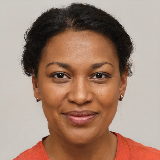 Joyful black adult female with short  brown hair and brown eyes